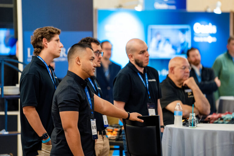 Attendees networking at sponsor booths during NeoSummit