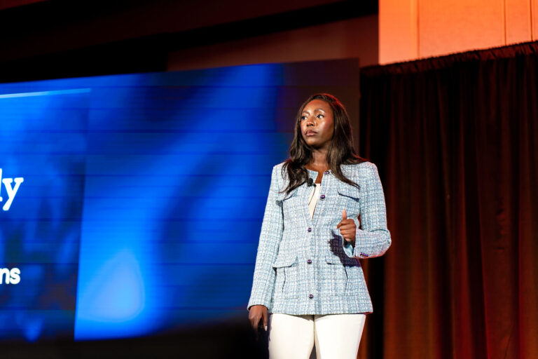 Speaker presenting on stage at NeoSummit in Fort Lauderdale