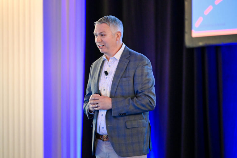 Speaker presenting on stage at Renaissance Cincinnati Downtown