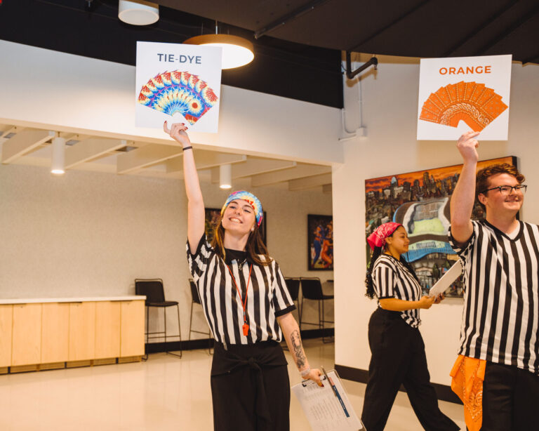 Referees holding team signs at a P&G team event at TQL Stadium