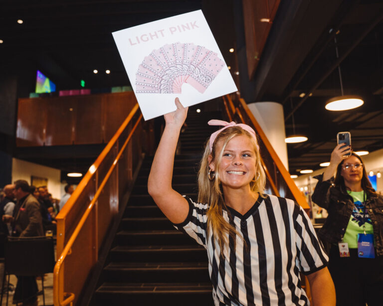 Referee with a team sign on the TQL Stadium stairs at a P&G event