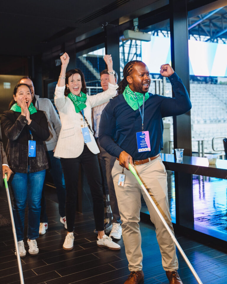 Cheering at shuffleboard during a P&G team event at TQL Stadium