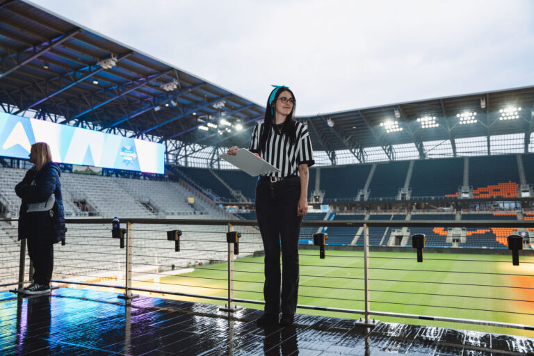 Referee on the TQL Stadium terrace overlooking the field at a P&G event