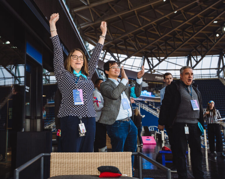 Cheering on the TQL Stadium terrace at a P&G team event