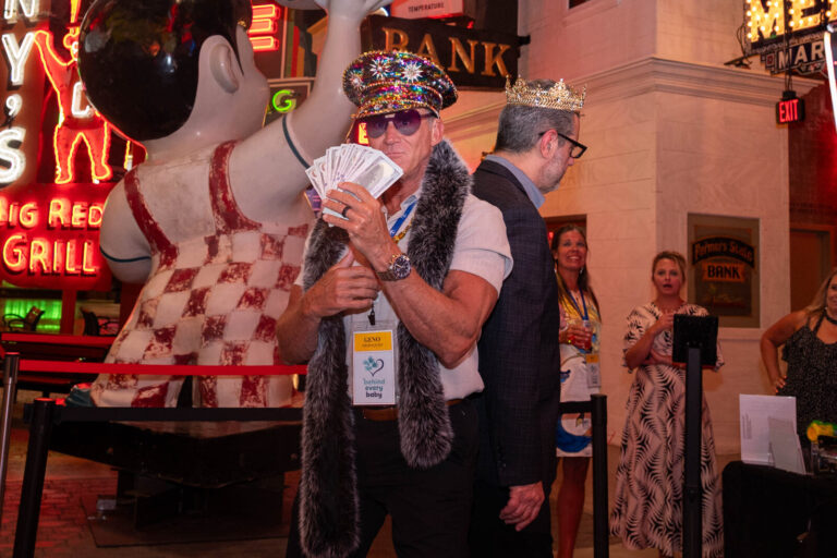 Guest in costume holding playing cards at the P&G Baby Care celebration, American Sign Museum Cincinnati