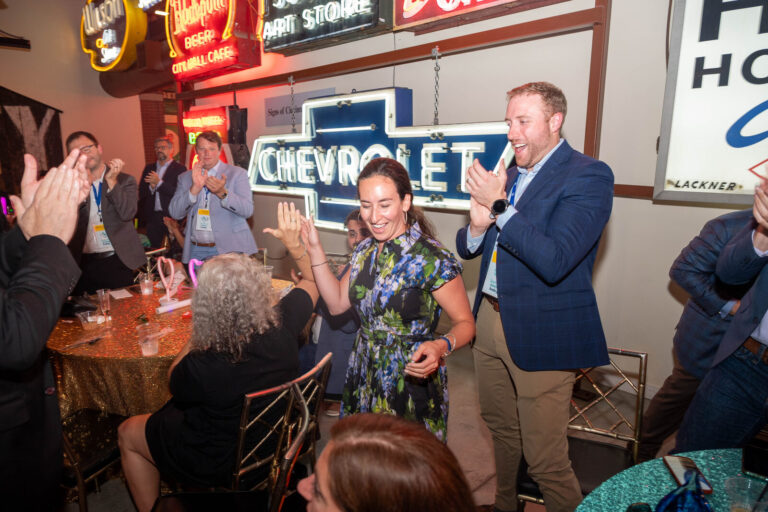Guests celebrating by the Chevrolet sign at the P&G Baby Care celebration, American Sign Museum Cincinnati