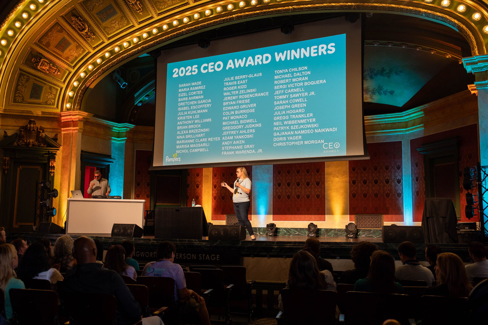 2025 CEO Award winners on screen in the historic hall at the P&G Baby Care event, Music Hall Cincinnati