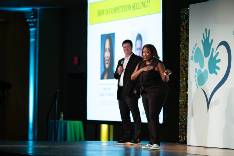 Two presenters on stage at the P&G Baby Care event, Music Hall Cincinnati