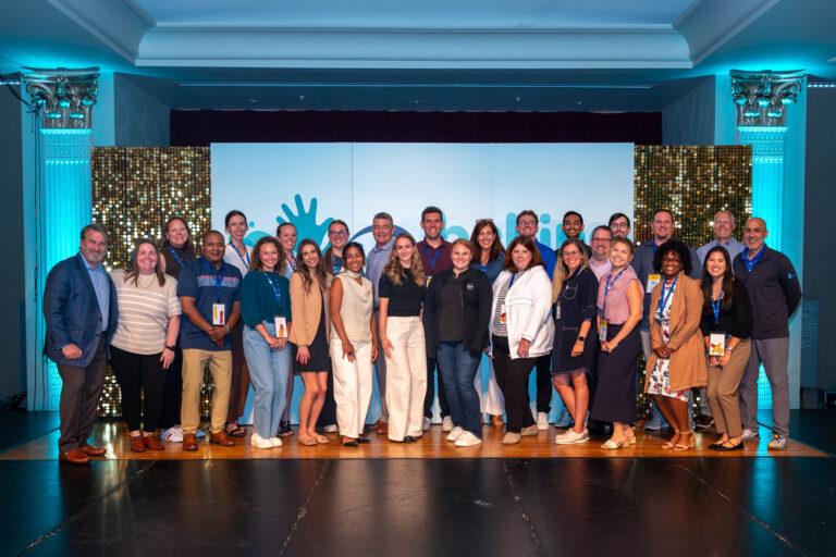 Team group photo on stage at the P&G Baby Care event, Music Hall Cincinnati