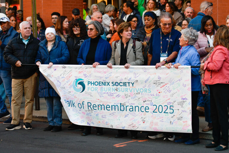 Survivors carrying the Walk of Remembrance 2025 banner in Covington