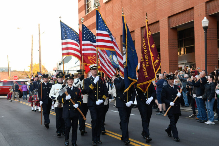 Honor guard with flags leading the Walk of Remembrance procession