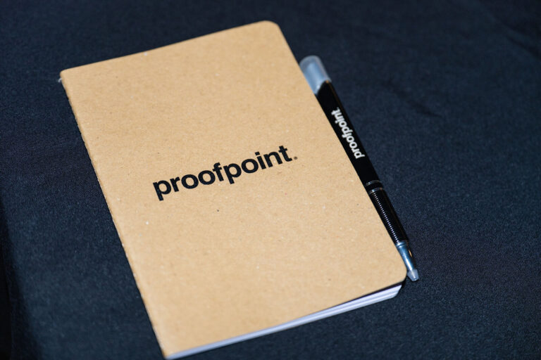 Proofpoint branded notebook and pen at the customer event