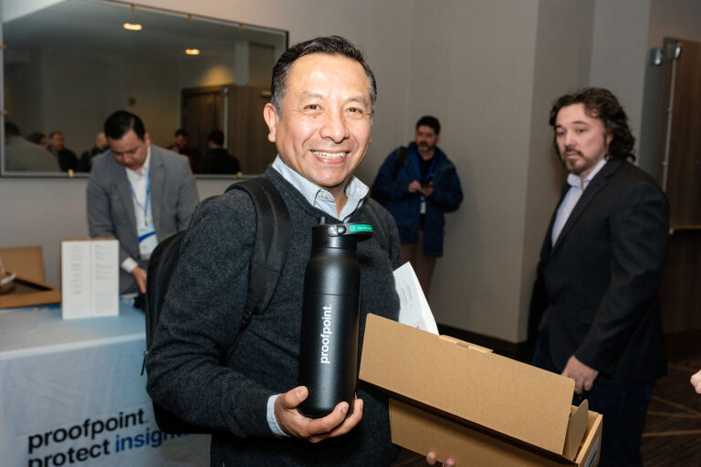 Attendee holding a Proofpoint water bottle gift