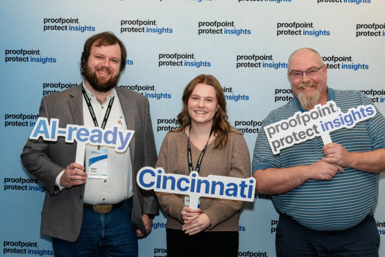 Attendees posing at the Proofpoint Protect Insights photo backdrop