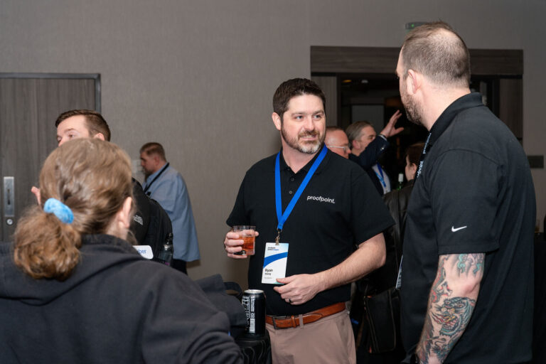 Attendees networking at the Proofpoint customer reception