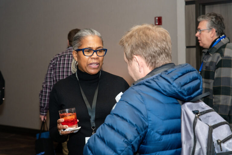 Attendees talking during the networking reception