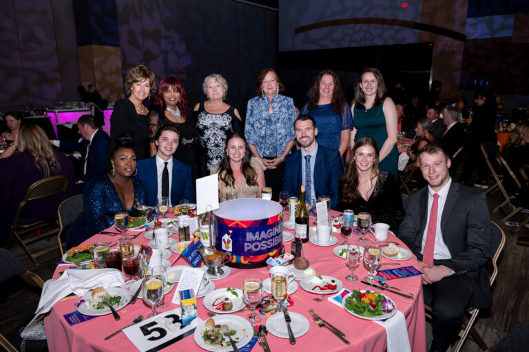 Guests posing at their table at the Ronald McDonald House Charities gala, Northern Kentucky Convention Center
