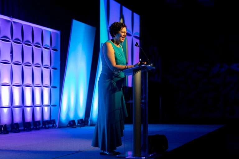Speaker at the podium on stage at the Ronald McDonald House Charities gala, Northern Kentucky Convention Center