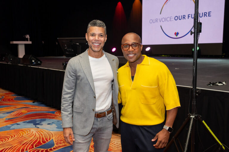 Two guests posing by the stage at the Zeno Group P&G GABLE event, Hard Rock Casino Cincinnati